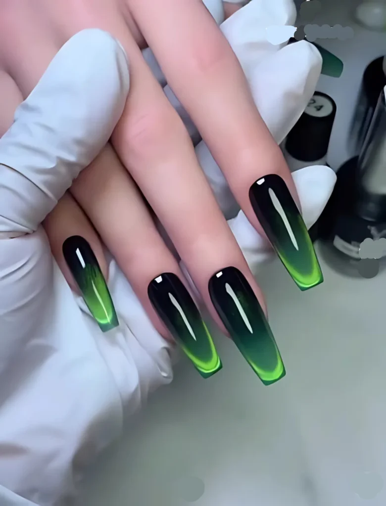 Black and green gradient nail art with long, sharp nails, exuding a bold and edgy vibe. Perfect for those who like to make a statement with their nails