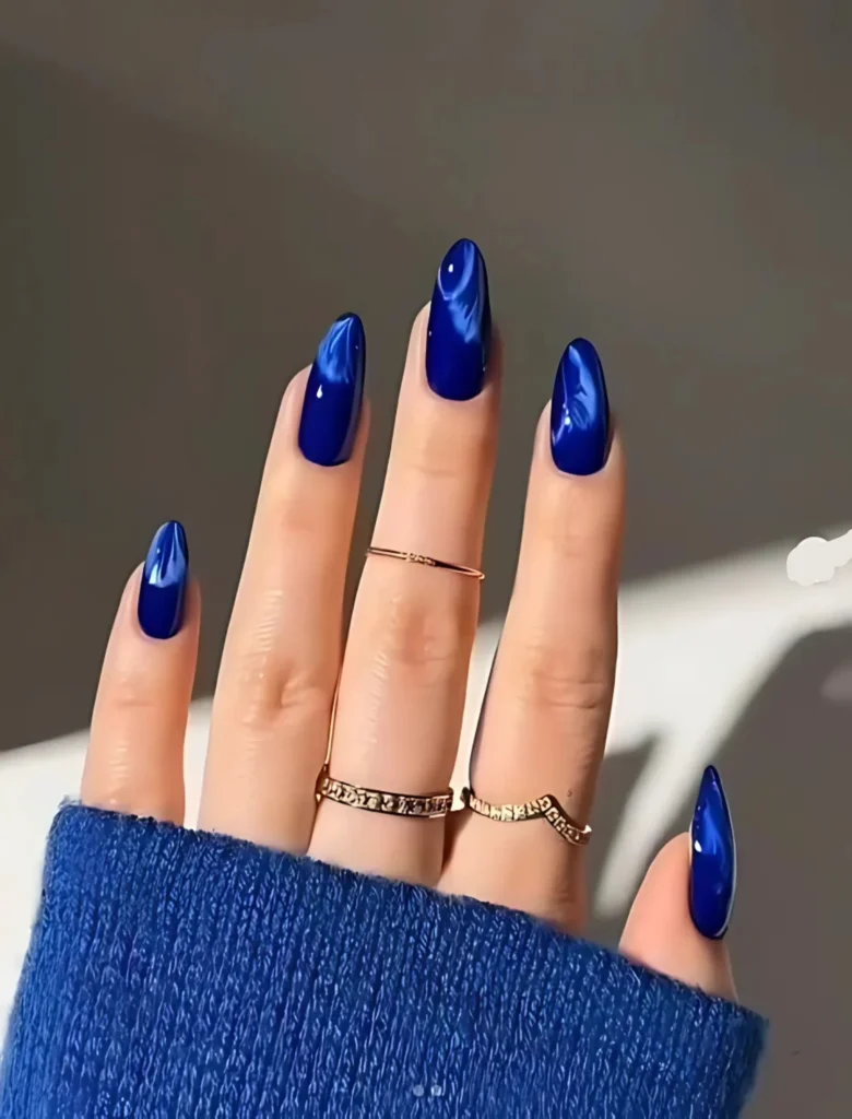 old blue glossy nail art with an elegant shine and silver rings