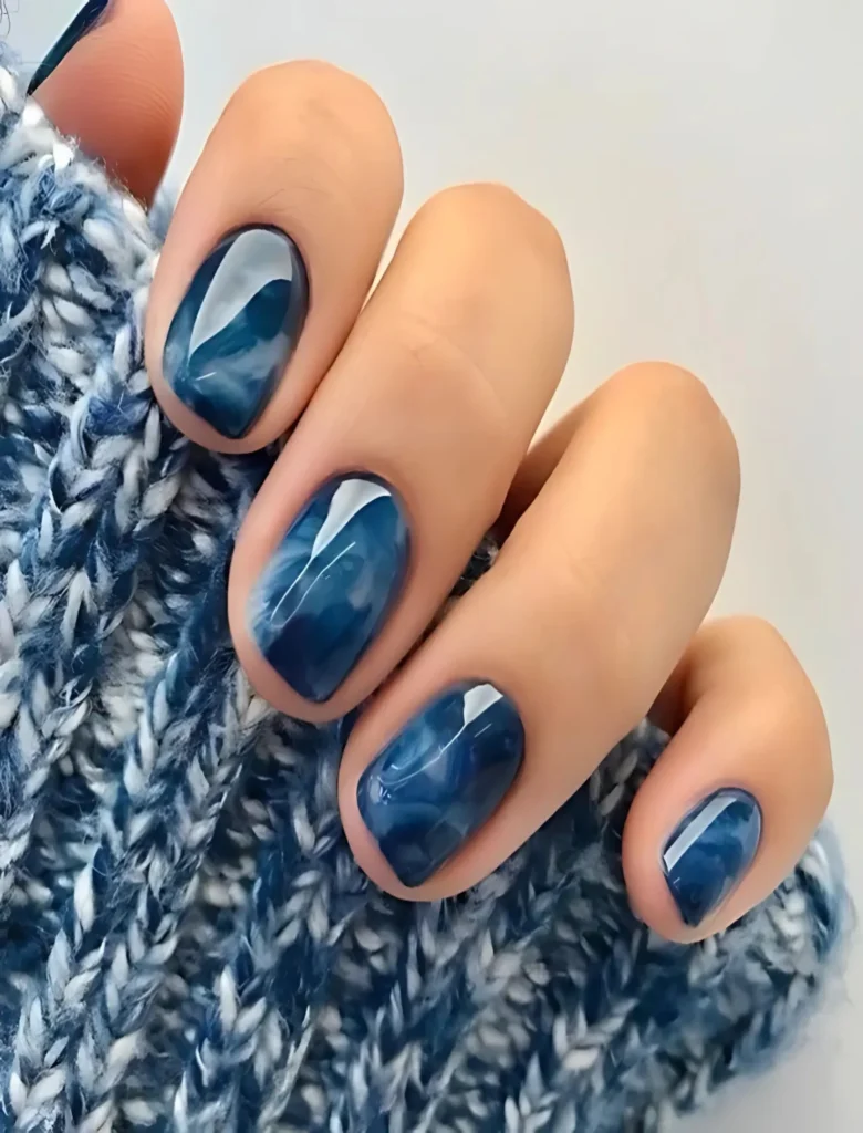 Marbled blue and white nail art with fluid patterns, creating a sophisticated and artistic design. A great choice for adding a touch of creativity to your nails